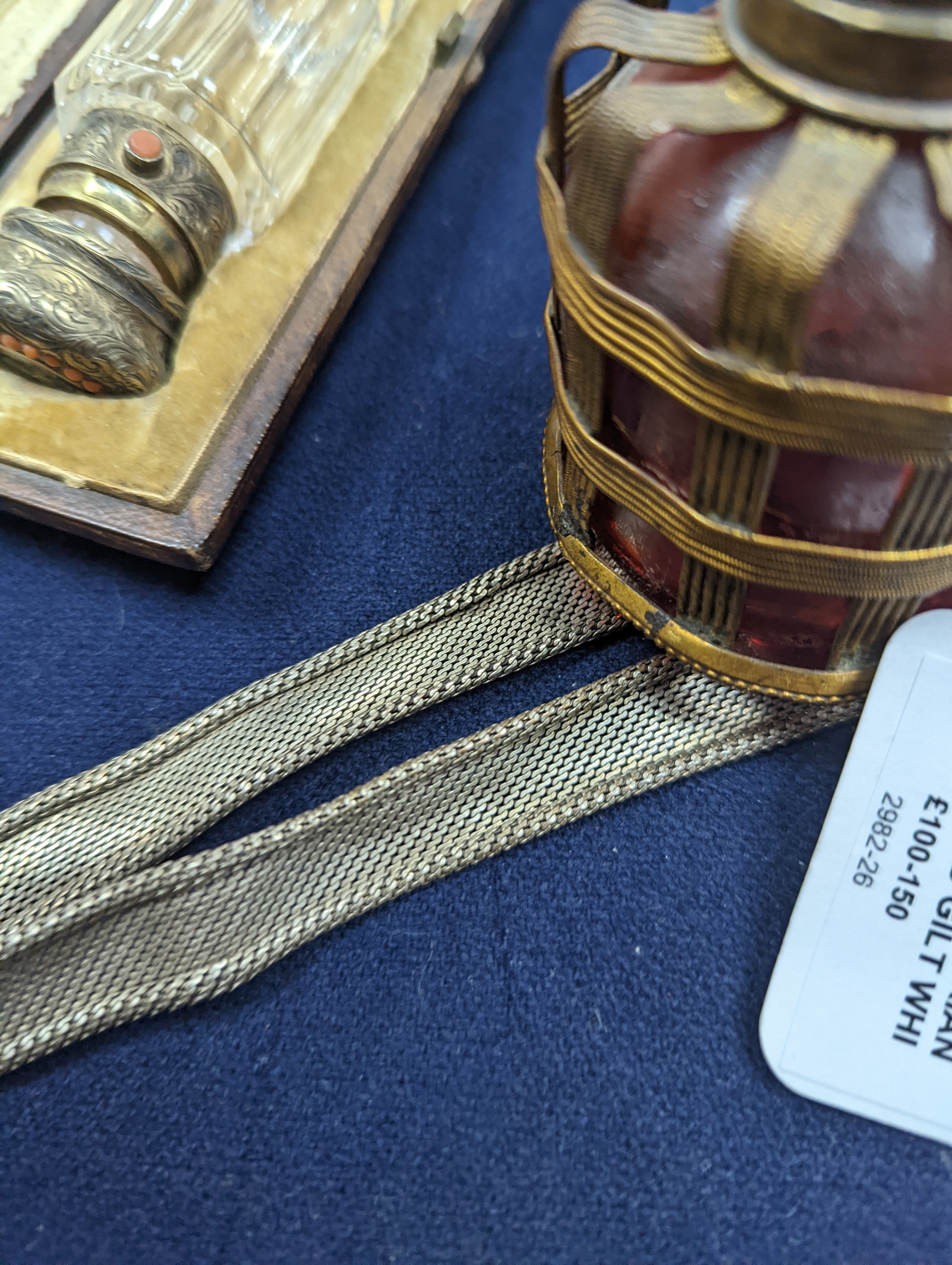 A cased Victorian engraved gilt white metal and coral set double ended scent bottle, 13.4cm, a silver cigar cutter, a belt, a silver buckle, gilt and cranberry perfume bottle, etc.